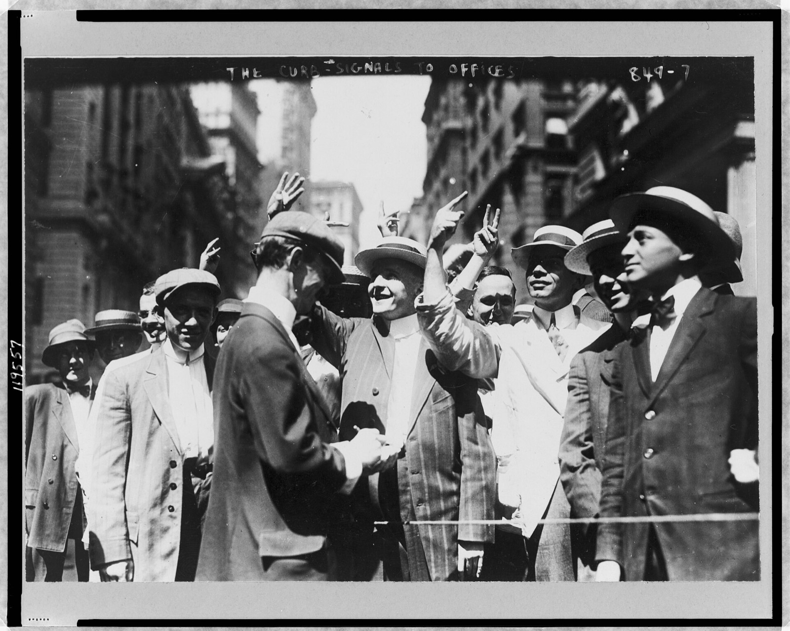 Brokers in straw hats on a New York street raising their hands to signal prices to offices above